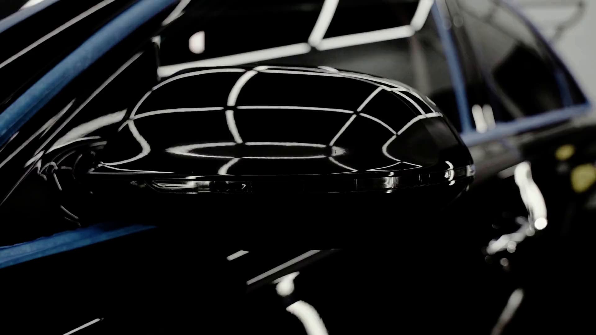 Studio light streaks reflected in black paint